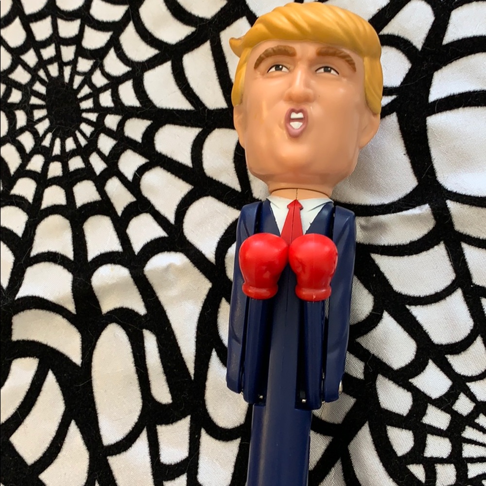 Donald Trump talking, punching pen.